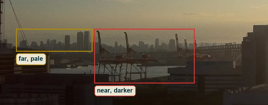 Left skyline in haze with the pale far towers and the darker nearer cranes marked
