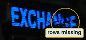 Pixel-level crop of the blue LED sign where the last letters break into dots