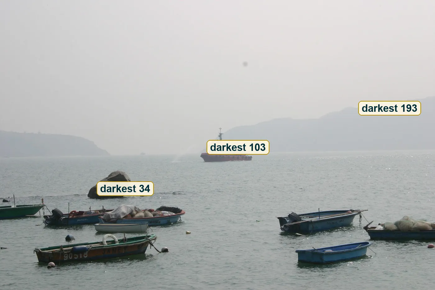 Full photo with three brightness readings, on the near rock, the ship and the far ridge
