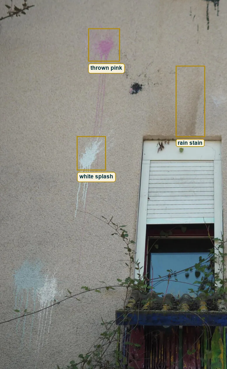 Left half of the wall with the pink paint burst, the white splash and the dark water stain marked